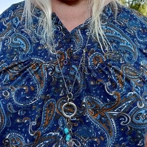 A silver style necklace with blue stones.